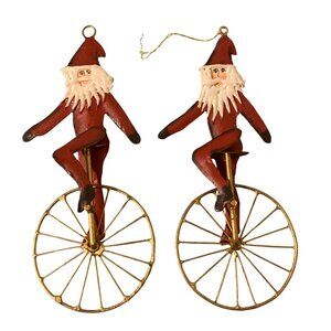 1992 Charlene Smith Signed Metal Ornament of Santa on a Unicycle Set Of 2